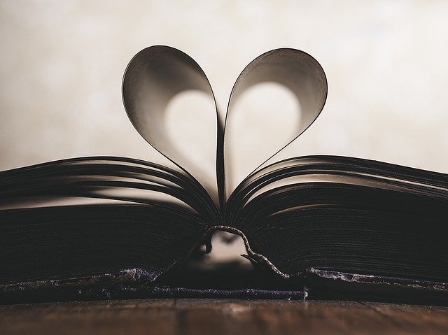 Open book with pages folded into a heart